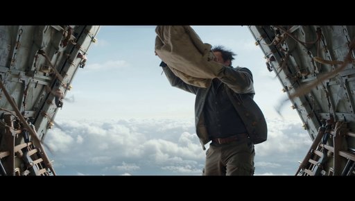 Cinematic Medium Shot Inside A Flying Cargo Airplane With The Rear Ramp Wide Open. A Rugged Man Wearing A Work Jacket Is